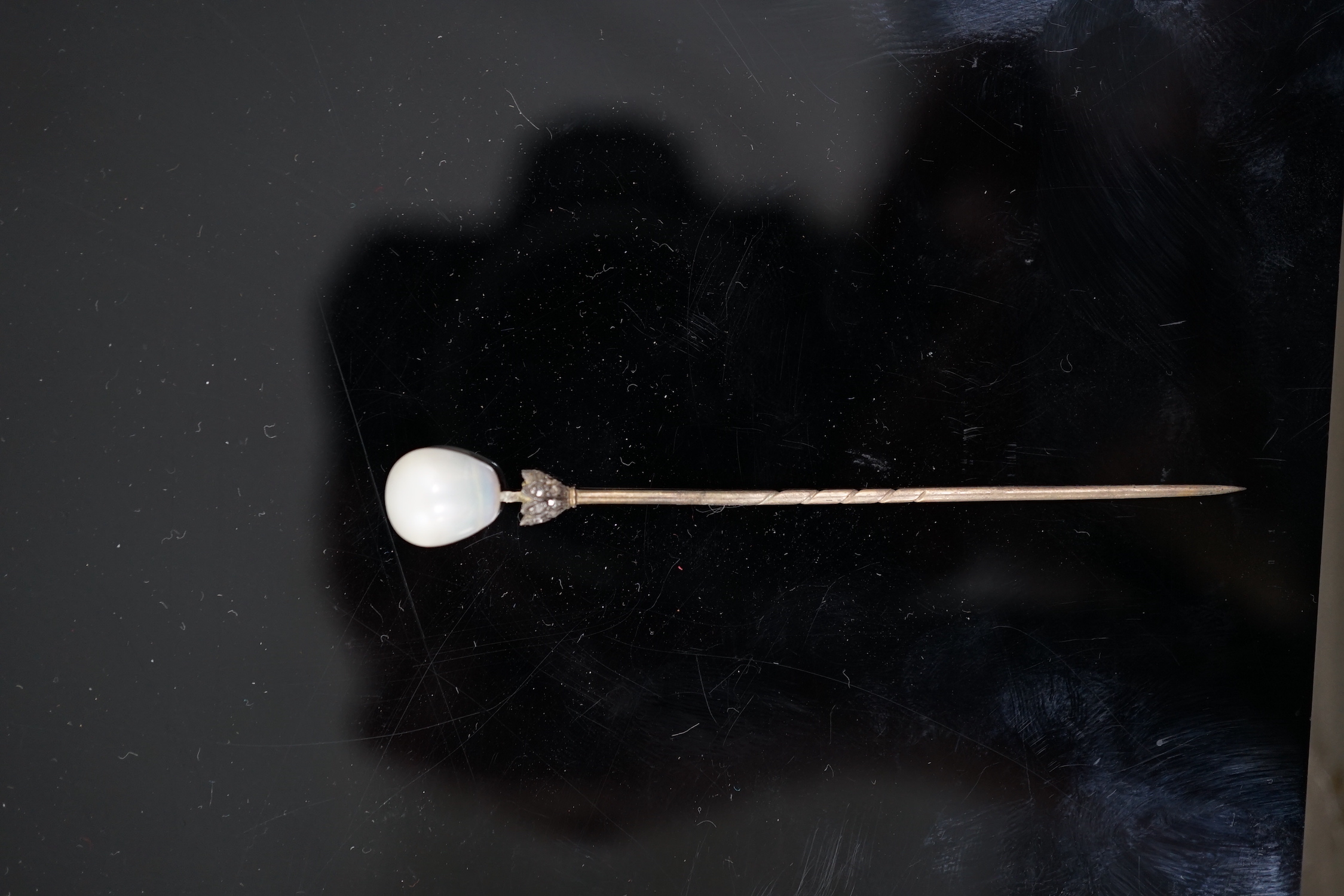 A Victorian gold, single stone part drilled natural saltwater pearl and rose cut diamond chip set stick pin